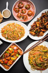 Assorted Indo chinese dishes in group includes Schezwan/Szechuan hakka noodles, veg fried rice, veg manchurian, american chop suey, chilli paneer, crispy vegetable and vegetable soup