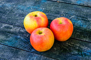 Pile of the ripe apples on wooden table
