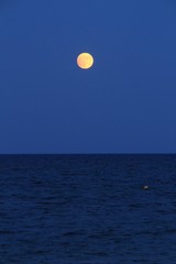 Alicante Beach at dusk with a full moon