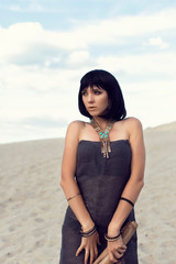 Young girl in the desert dressed in Egyptian style