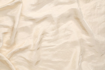 Soft smooth beige silk fabric background. Fabric texture.