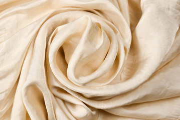 Soft smooth beige silk fabric background. Fabric texture.