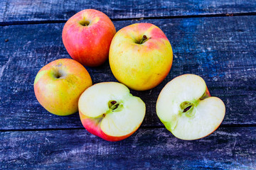 Pile of the ripe apples on wooden table