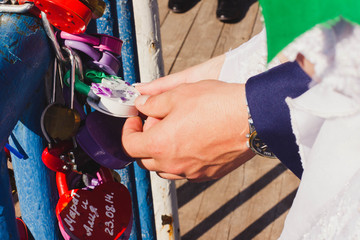 hands newlyweds with lock