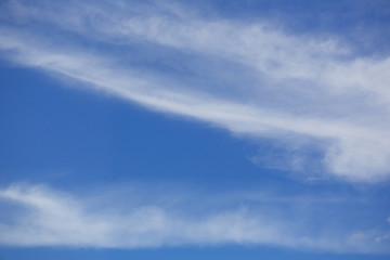 Sky with cumulus clouds. The background is blue and white. Bright sunny day. Copy space.