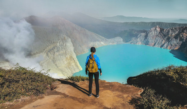 Woman standing on edge of crater  Kawah Ijen volcano, East Java, Indonesia