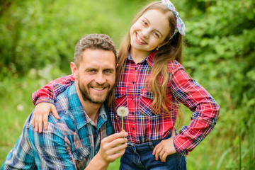 Fototapeta premium daughter and father with dandelion. spring village country. ecology. Happy family day. little girl and happy man dad. earth day. family summer farm. Helping in garden