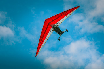 Ultralight aircraft flight in the blue air with clowds