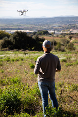 Man playing with drone on the open field