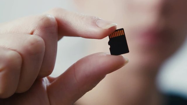 Micro sd card data storage technology held, depth of field shot