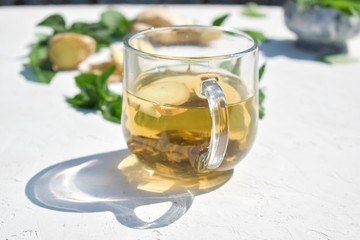 Cosmetic oil on a background of mint and ginger ingredients