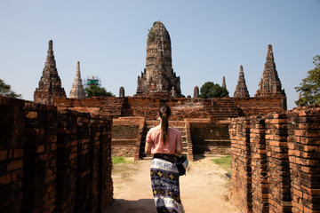 Woman visiting thai temple ruins in Ayuthaya