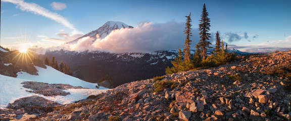 Mount Rainier towers over the surrounding mountains sitting at an elevation of 14,411 ft. It is...