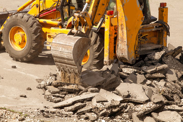 Fototapeta premium Tractor Dismantles Asphalt