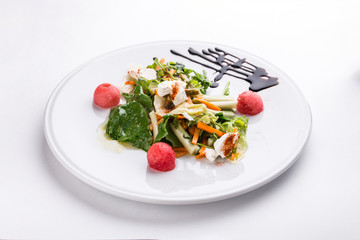 salad with fresh vegetables and cream cheese on white plate isolated on white background