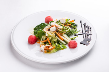 salad with fresh vegetables and cream cheese on white plate isolated on white background