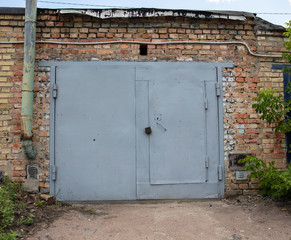 old metal door to the car garage