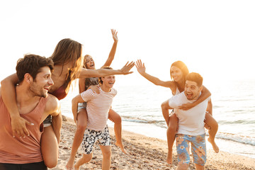 Group of cheerful happy young friends having fun