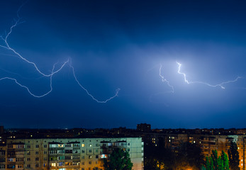 Thunderstorm with lightning and thunder over the night city
