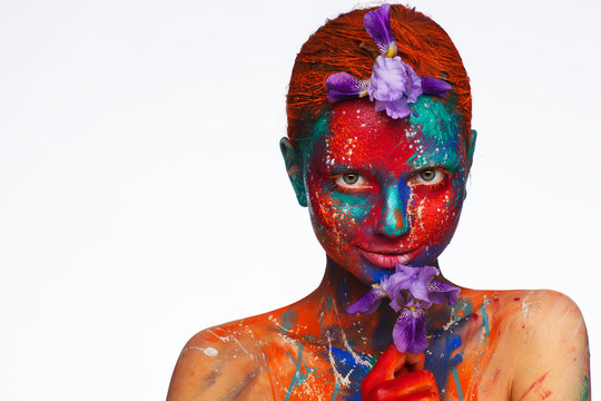 Creative fantastic makeup using colorful paints on the model