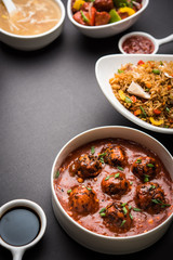 Assorted Indo chinese food in group includes non vegetarian or chicken Schezwan/Szechuan hakka noodles, fried rice, manchurian, egg american chop suey, soup with spoon and chop sticks, selective focus