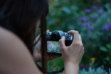 Girl taking pictures with mirrorless camera