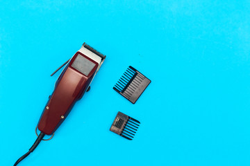  machine for a hairstyle. Barbershop. Hair clippers isolated on blue background. The machine for a...