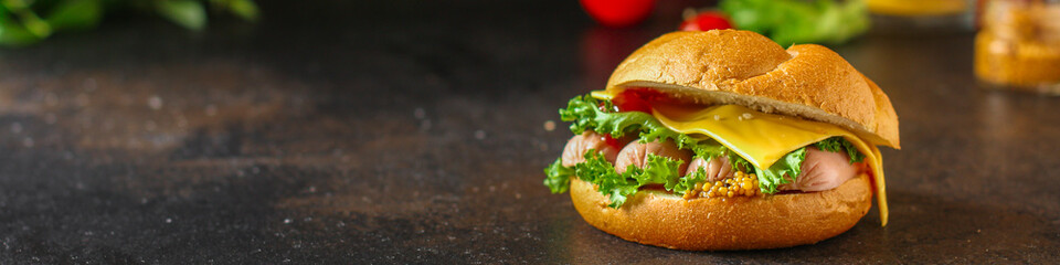 burger with sausages, cheese, lettuce, tomato sauce (snack sandwich, kaiser bun). top food background. copy space