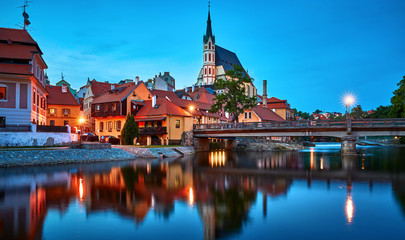 Czech Krumlov, Czech Republic. Evening view at bridge in old town with old houses and broach at...