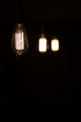 Lamps with tungsten filament. Edison's light bulb. Filament filament in vintage lamps. Retro design of light bulbs.