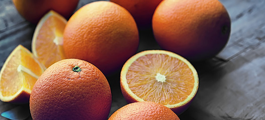Orange citrus fruit on a stone table. Orange background.