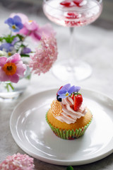 Cupcake decorated with buttercream, fruits and flowers