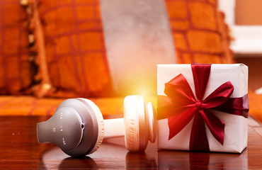 Music gift concept. Headphones and gift box. Top view with space for your greetings, holidays concept