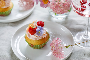 Cupcake decorated with buttercream, fruits and flowers