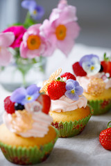 Cupcake decorated with buttercream, fruits and flowers