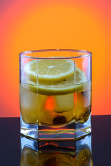 whiskey in a glass with ice and lemon