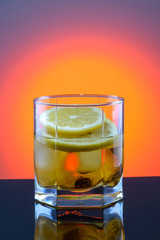 whiskey in a glass with ice and lemon