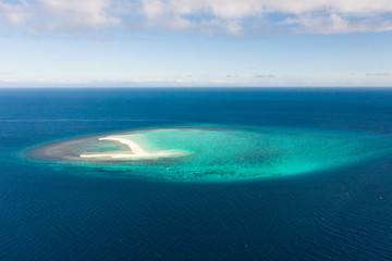 Fototapeta na wymiar White sandy island with coral reefs.White sandbar.Atoll near the island of Camiguin, Philippines, aerial view.Seascape, white sand island