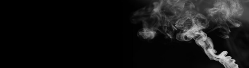 White smoke on a black background. Texture of smoke. Clubs of white smoke on a dark background for...