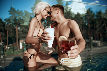 Close up of tasty summer cocktails situating in human arms