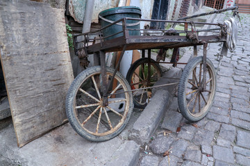 Fototapeta na wymiar very old and rusty vendor wheelbarrow on a poor street