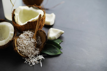 Coconut on a dark stone table. Coconut oil.