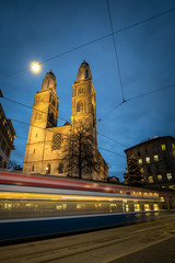 Zurich, Switzerland - view of the Grossmünster church with motion blurred tramway during Chrostmas...
