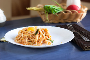 Delicious pasta with egg yolk, on wooden table.