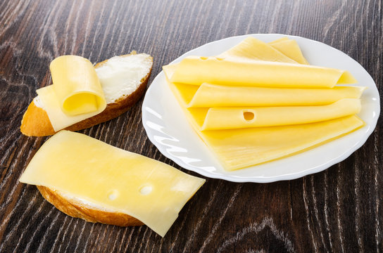 Sandwiches With Butter, Cheese, Slices Of Cheese In Plate On Wooden Table