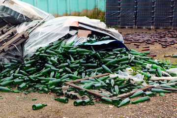 abandoned glass factory. packed bottles in pallets, broken bottles on asphalt, lots of loose...