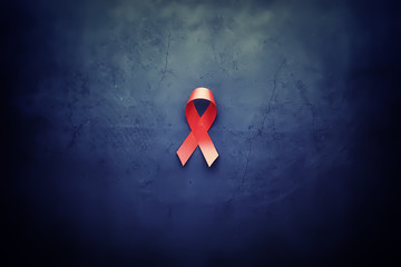 Symbol of human immunodeficiency virus disease. Red ribbon. A helping hand and support.