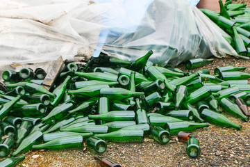 abandoned glass factory. packed bottles in pallets, broken bottles on asphalt, lots of loose...
