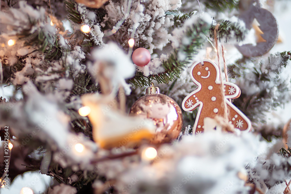 Wall mural toy gingerbread man hanging on a Christmas tree