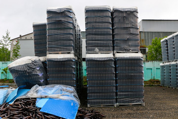 abandoned glass factory. packed bottles in pallets, broken bottles on asphalt, lots of loose...